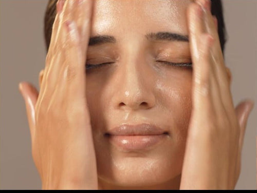 Model massaging cleansing balm into skin